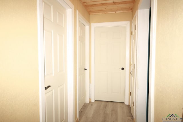 hallway featuring wooden ceiling and light hardwood / wood-style flooring