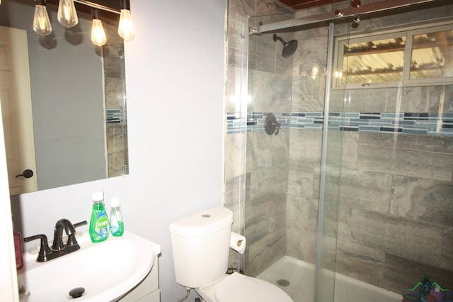 bathroom with vanity, toilet, and an enclosed shower