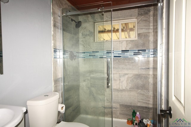 bathroom featuring vanity, toilet, and an enclosed shower