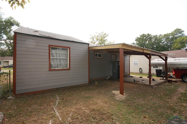 rear view of property featuring a yard