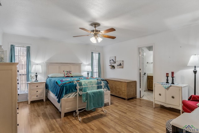 bedroom with light wood finished floors and a ceiling fan