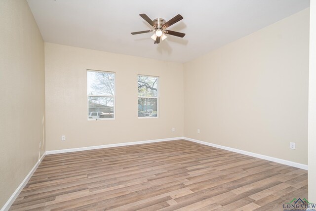 1104 N Bolivar St, Marshall, TX 75670 - spare room featuring baseboards, ceiling fan, and light wood finished floors