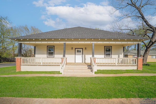 1104 N Bolivar St, Marshall, TX 75670 - bungalow-style home with a front lawn, covered porch, and roof with shingles
