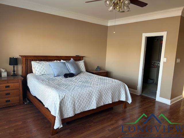 bedroom featuring ornamental molding, dark hardwood / wood-style floors, and ceiling fan