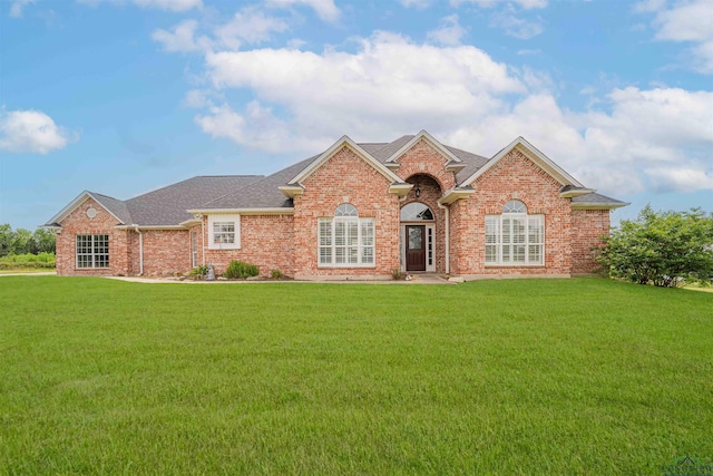20064 Fm 1716 E, Tatum, TX 75691 - single story home with a front lawn, a shingled roof, and brick siding