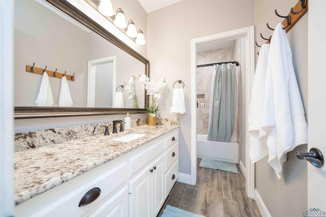 20064 Fm 1716 E, Tatum, TX 75691 - full bathroom featuring baseboards, vanity, wood finished floors, and shower / bath combo