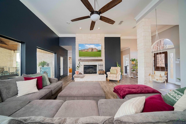 20064 Fm 1716 E, Tatum, TX 75691 - living room with ceiling fan, visible vents, crown molding, wood finished floors, and ornate columns