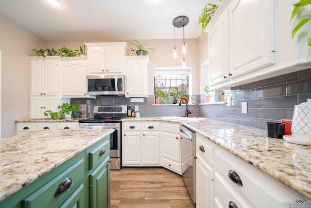 20064 Fm 1716 E, Tatum, TX 75691 - kitchen with a sink, stainless steel appliances, tasteful backsplash, light wood finished floors, and white cabinetry