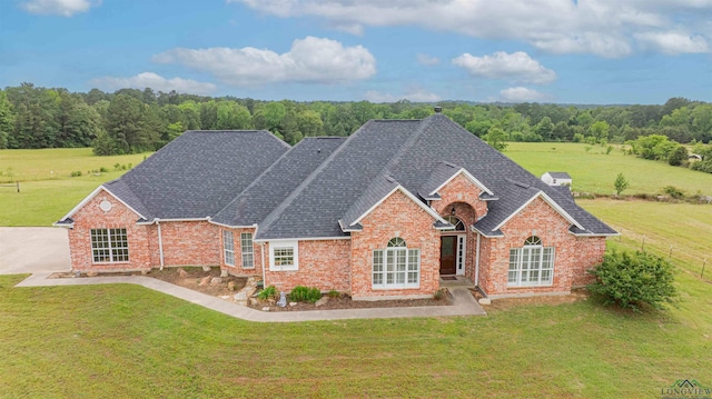 20064 Fm 1716 E, Tatum, TX 75691 - view of front of home with a shingled roof, a front lawn, and brick siding