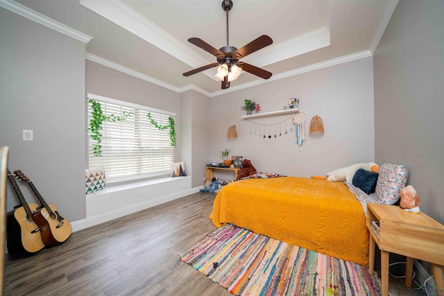 20064 Fm 1716 E, Tatum, TX 75691 - bedroom with wood finished floors, baseboards, a raised ceiling, ceiling fan, and ornamental molding