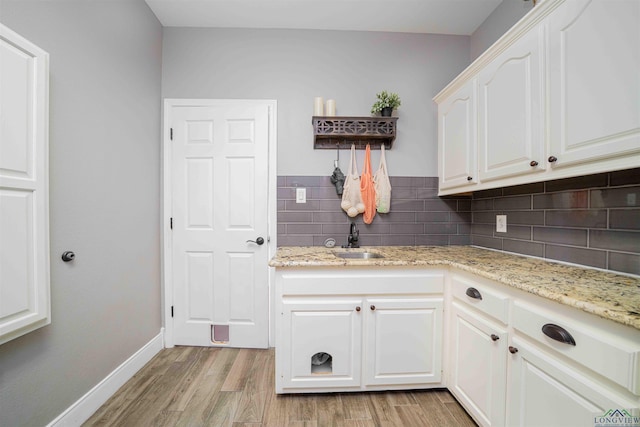 20064 Fm 1716 E, Tatum, TX 75691 - laundry area featuring a sink, baseboards, and light wood-style floors