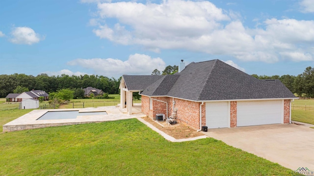 20064 Fm 1716 E, Tatum, TX 75691 - view of property exterior featuring an attached garage, fence, a lawn, an outdoor structure, and brick siding