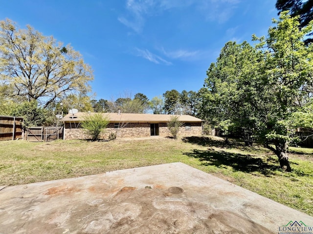 exterior space featuring a yard, fence, and a patio area