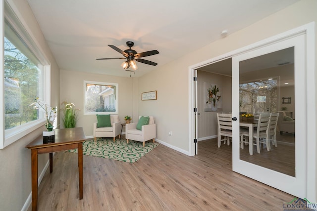 sitting room with ceiling fan and light hardwood / wood-style floors