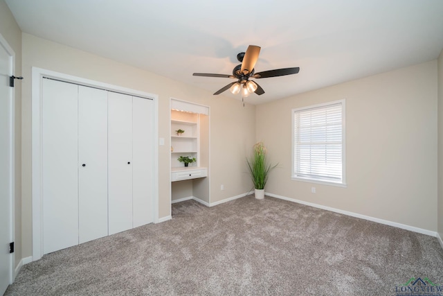 unfurnished bedroom featuring ceiling fan, light colored carpet, and a closet