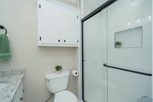 bathroom with vanity, toilet, and walk in shower