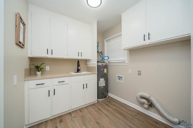 laundry area with sink, electric dryer hookup, cabinets, electric water heater, and light hardwood / wood-style floors