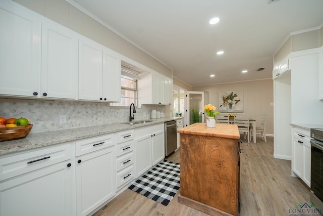 kitchen featuring white cabinetry, sink, stainless steel dishwasher, light stone counters, and crown molding