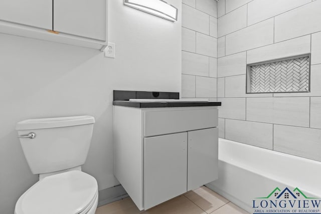 bathroom featuring vanity, a bathtub, tile patterned flooring, and toilet