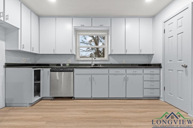 kitchen featuring white cabinetry, sink, light hardwood / wood-style flooring, and dishwasher