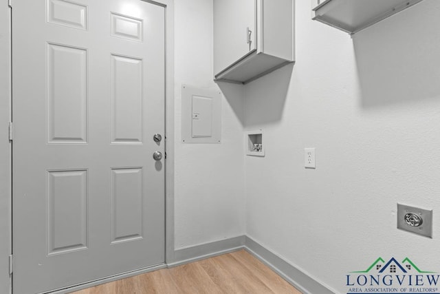 laundry room with light hardwood / wood-style flooring, electric dryer hookup, electric panel, cabinets, and washer hookup