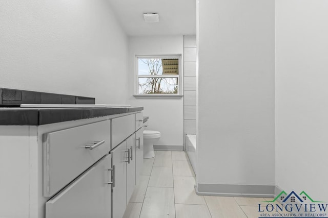 bathroom with vanity, tile patterned floors, and toilet