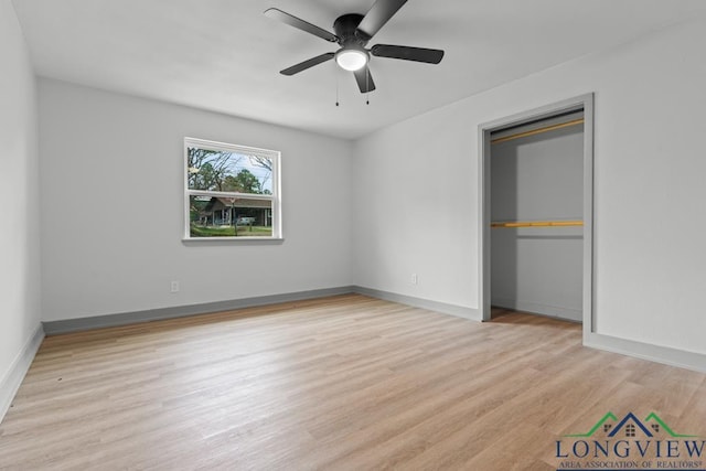 unfurnished bedroom featuring ceiling fan, a closet, and light hardwood / wood-style flooring