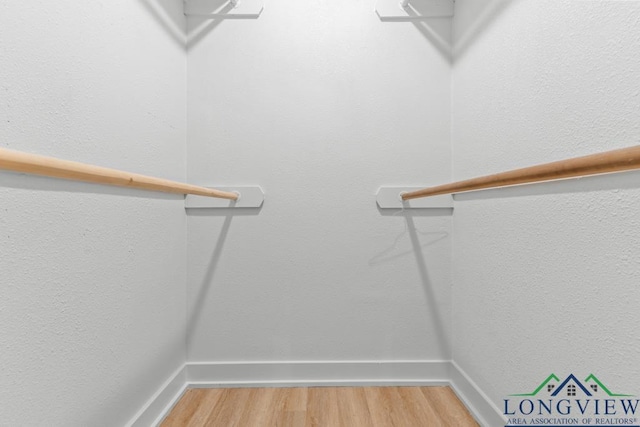 walk in closet featuring hardwood / wood-style floors