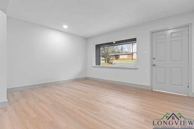 empty room with light hardwood / wood-style flooring