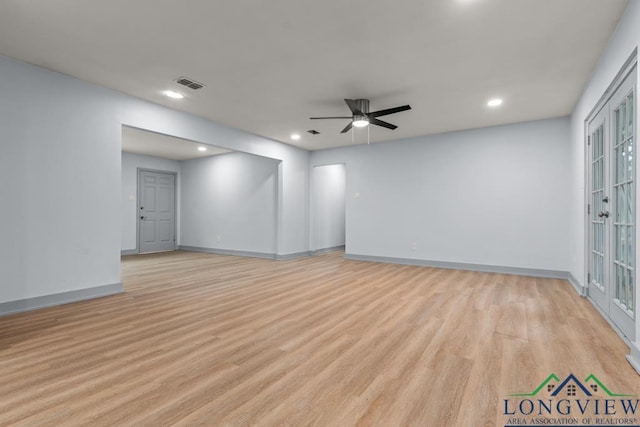 empty room with ceiling fan and light wood-type flooring