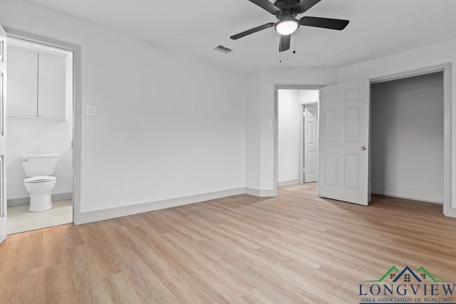 unfurnished bedroom featuring connected bathroom, ceiling fan, and light wood-type flooring