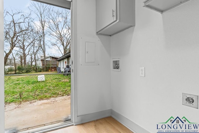 laundry room with electric dryer hookup, washer hookup, and light hardwood / wood-style flooring