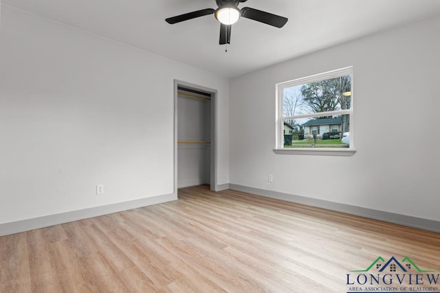 unfurnished bedroom with ceiling fan, a closet, and light wood-type flooring