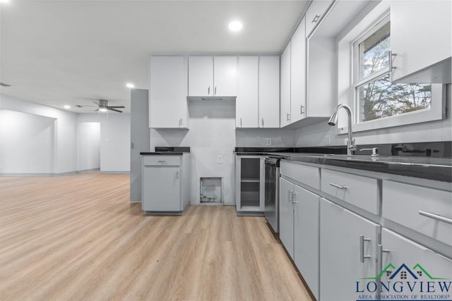 kitchen featuring white cabinetry, sink, ceiling fan, and light hardwood / wood-style floors