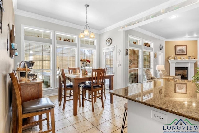 1900 Frostwood Dr, Tyler, TX 75703 - dining space featuring a fireplace, light tile patterned floors, plenty of natural light, and crown molding