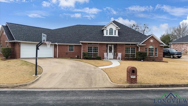 1900 Frostwood Dr, Tyler, TX 75703 - view of front facade with a garage, brick siding, and a shingled roof
