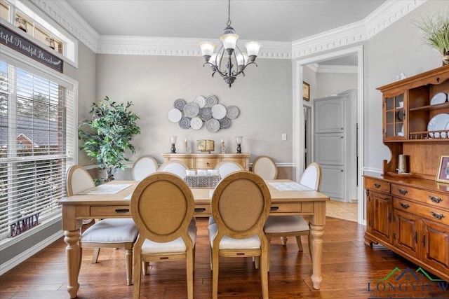 1900 Frostwood Dr, Tyler, TX 75703 - dining room featuring crown molding, hardwood / wood-style flooring, a chandelier, and baseboards