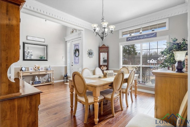 1900 Frostwood Dr, Tyler, TX 75703 - dining room featuring wood-type flooring, crown molding, an inviting chandelier, and baseboards