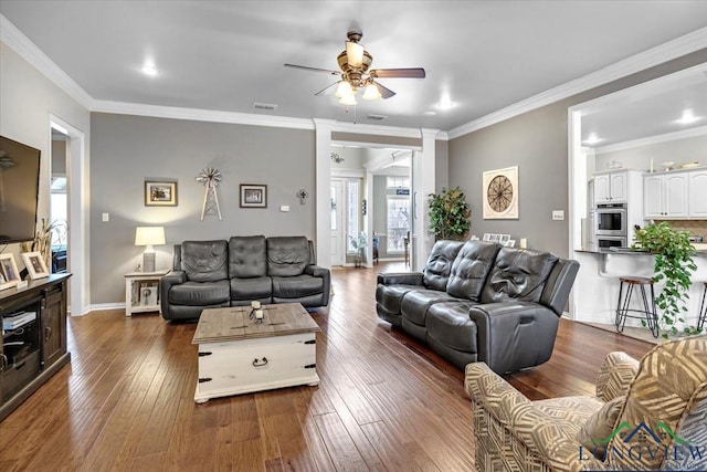 1900 Frostwood Dr, Tyler, TX 75703 - living area featuring ornamental molding, ceiling fan, baseboards, visible vents, and dark wood-type flooring