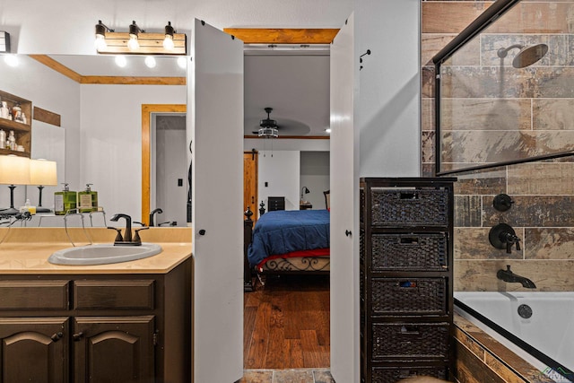 bathroom with vanity, ceiling fan, and plus walk in shower