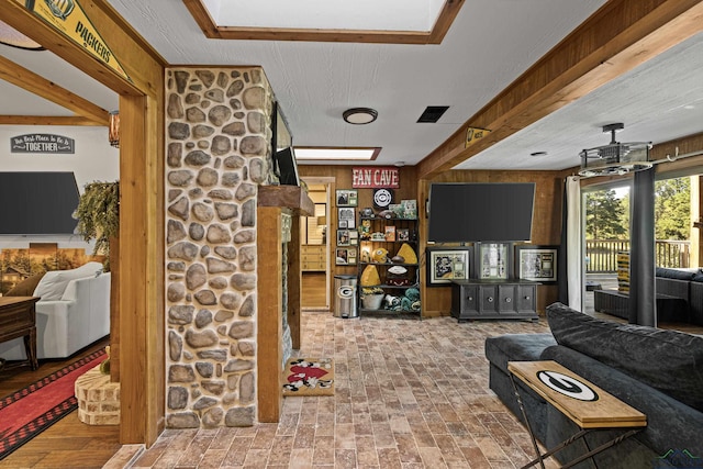 living room featuring wooden walls and a textured ceiling