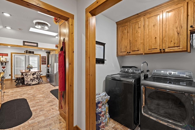 washroom featuring cabinets and independent washer and dryer