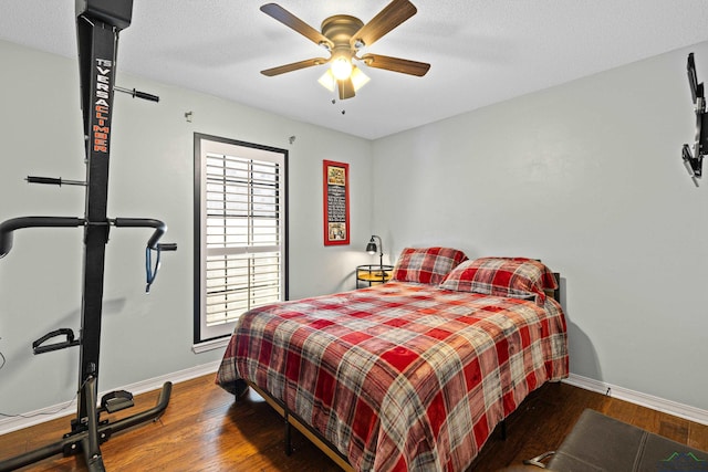 bedroom with ceiling fan and wood-type flooring