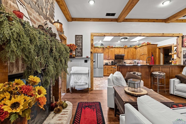 interior space featuring beam ceiling, dark hardwood / wood-style flooring, and sink