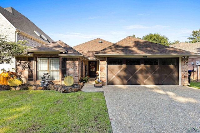 view of front of property with a garage and a front lawn