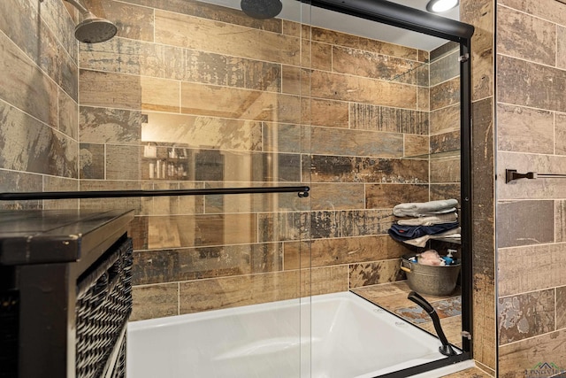 bathroom featuring bath / shower combo with glass door