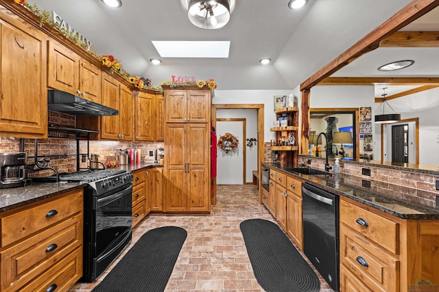 kitchen featuring sink, vaulted ceiling with skylight, black gas range oven, tasteful backsplash, and kitchen peninsula