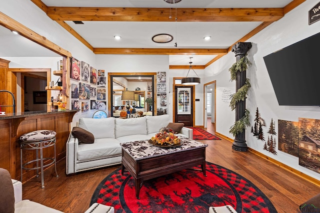 living room with beamed ceiling and dark wood-type flooring