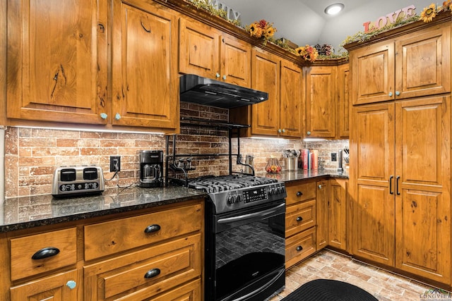 kitchen with backsplash, black gas range oven, dark stone counters, and vaulted ceiling