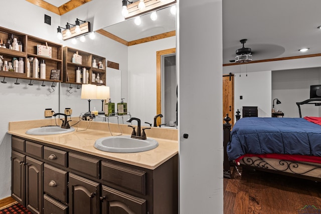 bathroom featuring ceiling fan, hardwood / wood-style floors, vanity, and ornamental molding